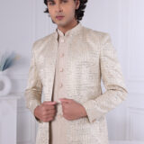 Man wearing an ivory malai silk Jodhpuri suit with sequin embroidery and geometric design.