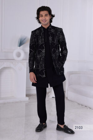 Man wearing a black Jodhpuri suit with sequin embroidery in geometric and floral design.