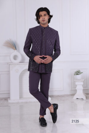 Man wearing a deep purple Jodhpuri suit with vertical sequin patterns and floral embroidery on sleeves and hem.