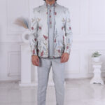 Man wearing a pastel blue floral embroidered Jodhpuri suit with contrast piping.