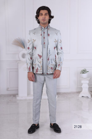 Man wearing a pastel blue floral embroidered Jodhpuri suit with contrast piping.