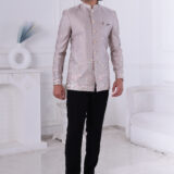 Man wearing an ivory silk embroidered Jodhpuri suit with pastel floral and elephant motifs.