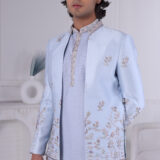 Man wearing a powder blue Jodhpuri suit with pastel floral embroidery and coordinated kurta-pajama.