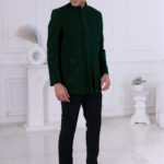 Man wearing an emerald green Jodhpuri suit with tonal floral embroidery, styled with a matching kurta and trousers.