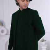 Man wearing an emerald green Jodhpuri suit with tonal floral embroidery, styled with a matching kurta and trousers.