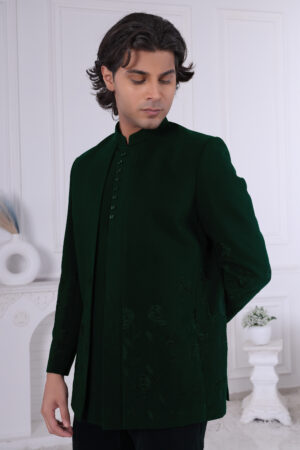 Man wearing an emerald green Jodhpuri suit with tonal floral embroidery, styled with a matching kurta and trousers.