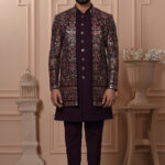 Men’s plum brocade Indo-Western with metallic embroidery and antique buttons.
