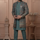 Men’s teal green embroidered Indo-Western jacket set with floral motifs and sequins.