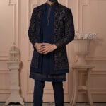 Men’s navy blue Indo-Western jacket set with golden zari embroidery.