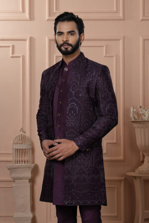 Men’s royal plum Indo-Western outfit with embroidered jacket featuring geometric patterns.