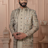 Men’s beige Indo-Western outfit with floral embroidery and mirror work jacket.