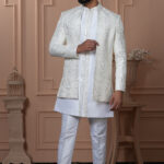 Men’s white Indo-Western with mirror work jacket, paired with plain white kurta and trousers.