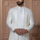 Men’s white Indo-Western with mirror work jacket, paired with plain white kurta and trousers.