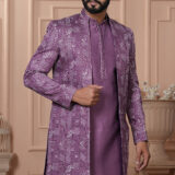 Men’s lavender Indo-Western with embroidered and mirror work jacket, paired with kurta and trousers.