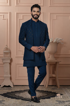 Men’s navy blue Indo-Western outfit with embroidered jacket, styled with matching kurta and trousers.