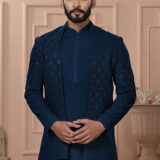 Men’s navy blue Indo-Western outfit with embroidered jacket, styled with matching kurta and trousers.
