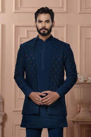 Men’s navy blue Indo-Western outfit with embroidered jacket, styled with matching kurta and trousers.