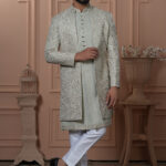 Men’s pastel green Indo-Western outfit with embroidered floral jacket and front-buttoned kurta.