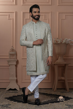 Men’s pastel green Indo-Western outfit with embroidered floral jacket and front-buttoned kurta.