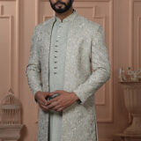 Men’s pastel green Indo-Western outfit with embroidered floral jacket and front-buttoned kurta.