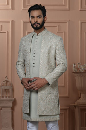Men’s pastel green Indo-Western outfit with embroidered floral jacket and front-buttoned kurta.