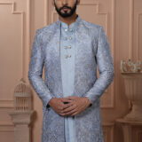 Men’s powder blue Indo-Western outfit with embroidered jacket and metallic buttoned kurta.