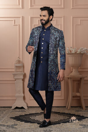 Men’s navy blue Indo-Western outfit with floral embroidered jacket and metallic button kurta.