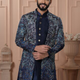Men’s navy blue Indo-Western outfit with floral embroidered jacket and metallic button kurta.