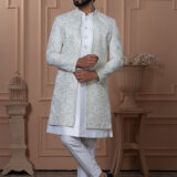 Men’s ivory white Indo-Western outfit with embroidered jacket and golden button kurta.