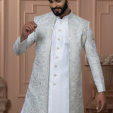 Men’s ivory white Indo-Western outfit with embroidered jacket and golden button kurta.