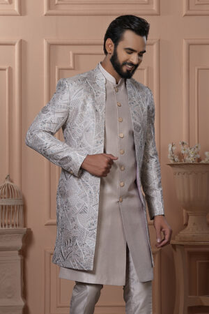 Men’s champagne beige Indo-Western outfit with silver embroidered jacket and matching kurta set.