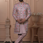 Men’s pastel pink Indo-Western outfit with multicolor embroidered jacket and matching kurta set.