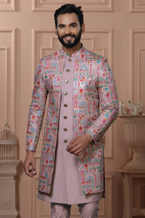 Men’s pastel pink Indo-Western outfit with multicolor embroidered jacket and matching kurta set.