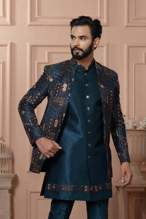 Men’s teal blue Indo-Western outfit with embroidered jacket and matching kurta set.