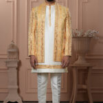 Men’s yellow Indo-Western outfit with ivory kurta and mirror work embroidered jacket.