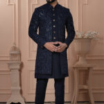 Men’s navy blue Indo-Western outfit with embroidered jacket and matching kurta set.