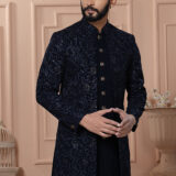 Men’s navy blue Indo-Western outfit with embroidered jacket and matching kurta set.