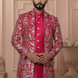 Man wearing a red embroidered Indo-Western with golden detailing.