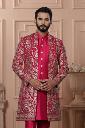 Man wearing a red embroidered Indo-Western with golden detailing.