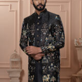 Man wearing a black embroidered Indo-Western with royal motifs and camel designs.