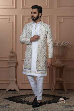 Man wearing an ivory embroidered Indo-Western with floral and palace motifs.