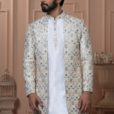 Man wearing an ivory embroidered Indo-Western with floral and palace motifs.