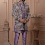 Man wearing a lavender Indo-Western outfit with intricately embroidered long jacket.