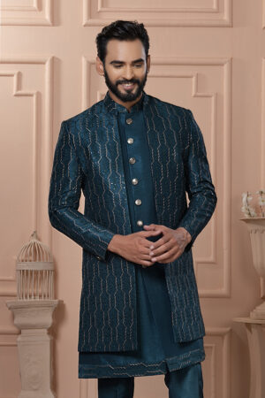 Man wearing teal Indo-Western outfit with textured embroidered long jacket.