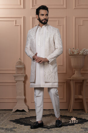 Man wearing an ivory Indo-Western outfit with a mirror-work embroidered long jacket.