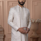 Man wearing ivory Indo-Western outfit with mirror work embroidered long jacket.