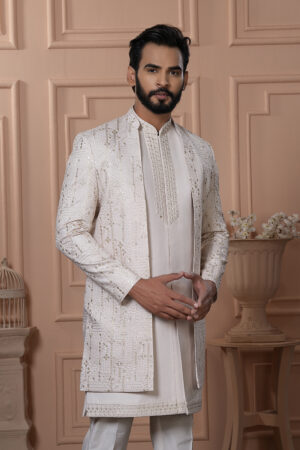 Man wearing ivory Indo-Western outfit with mirror work embroidered long jacket.