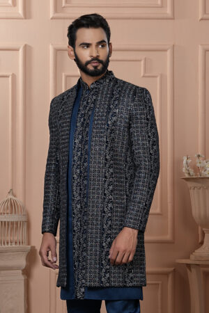 Man wearing navy Indo-Western outfit with all-over embroidered long jacket.