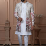 Man wearing white Indo-Western with a multicolor floral embroidered jacket.