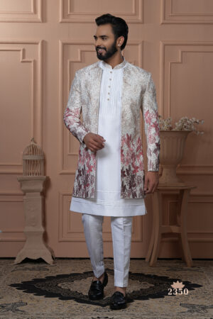 Man wearing white Indo-Western with a multicolor floral embroidered jacket.
